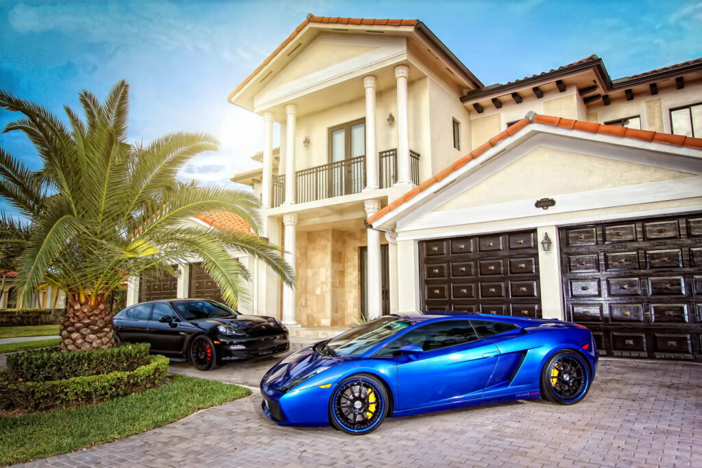 Luxury Living: Exquisite Mansion Showcasing Supercars in Classy Surroundings Wallpaper