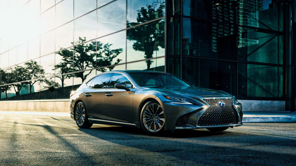 Sleek Metallic Gray Lexus LS 500h Wallpaper Against Modern Glass