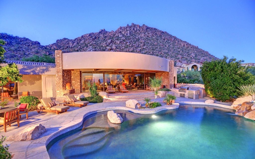 Modern desert home wallpaper with curved design pool mountain twilight serene outdoor living