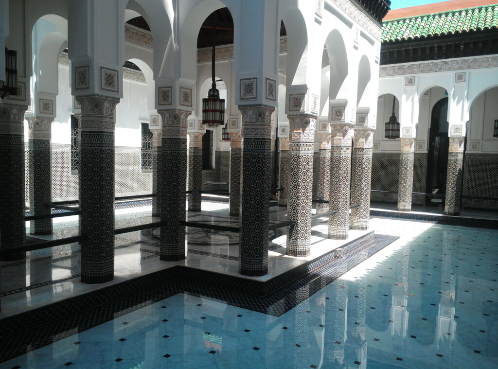 Luxurious Moroccan Hotel Wallpaper: Tilework & Serene Pool Design