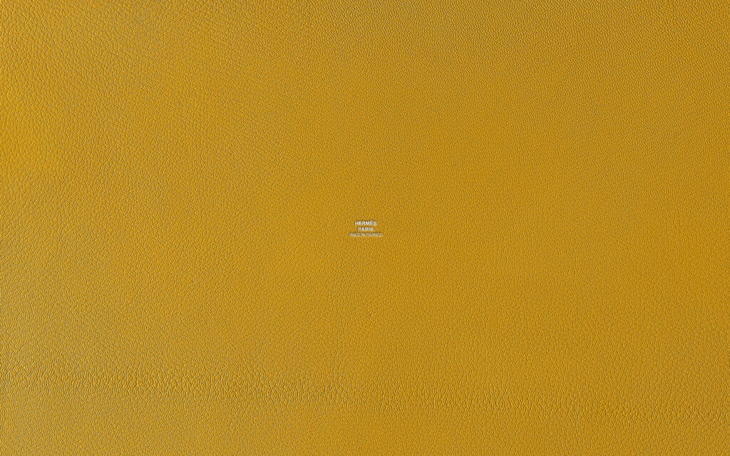 Mustard yellow textured wallpaper inspired by Hermes for luxury modern interior design background