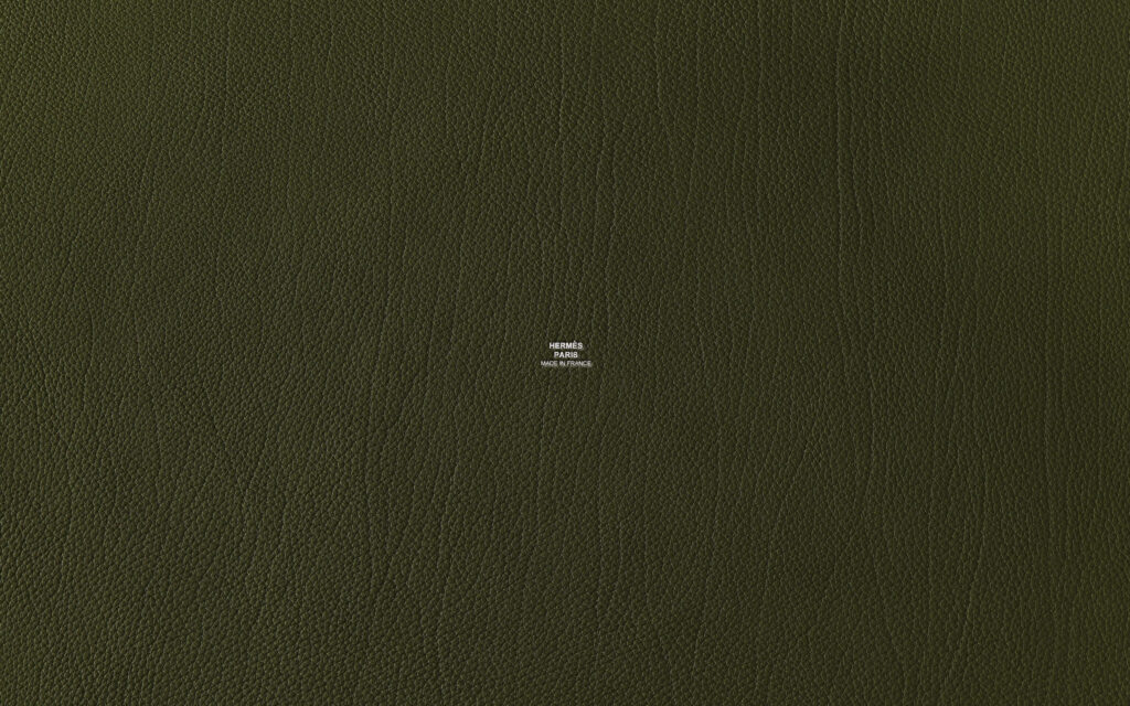 Luxurious olive green textured wallpaper with subtle Hermes logo elegant designer background