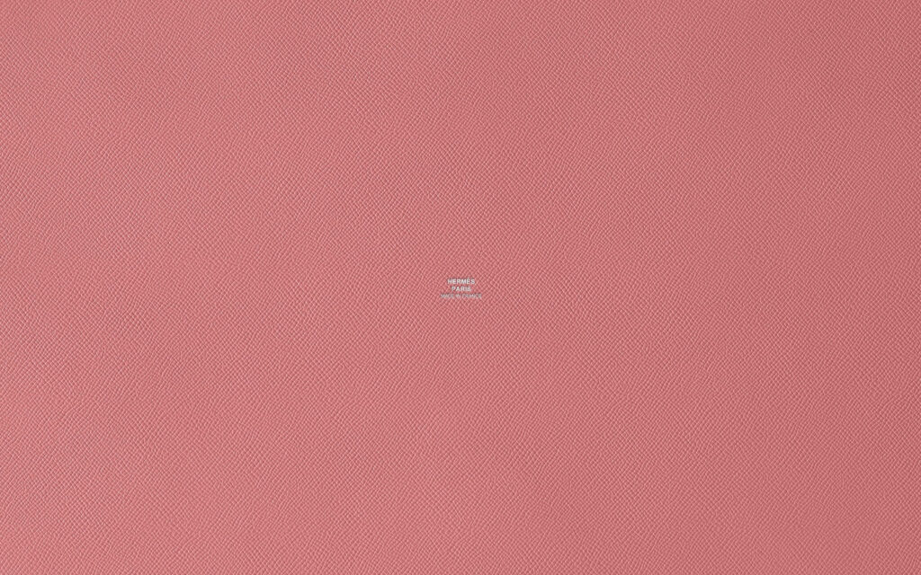 Luxurious salmon pink textured wallpaper inspired by elegant Hermes style background design