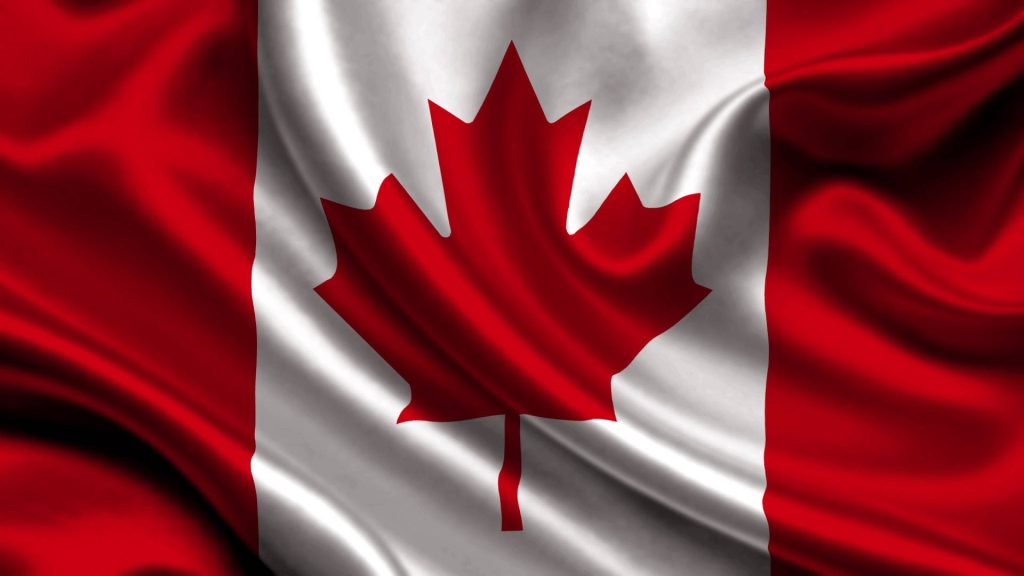 Silky Canadian flag wallpaper with vibrant red maple leaf and elegant flowing waves lighting