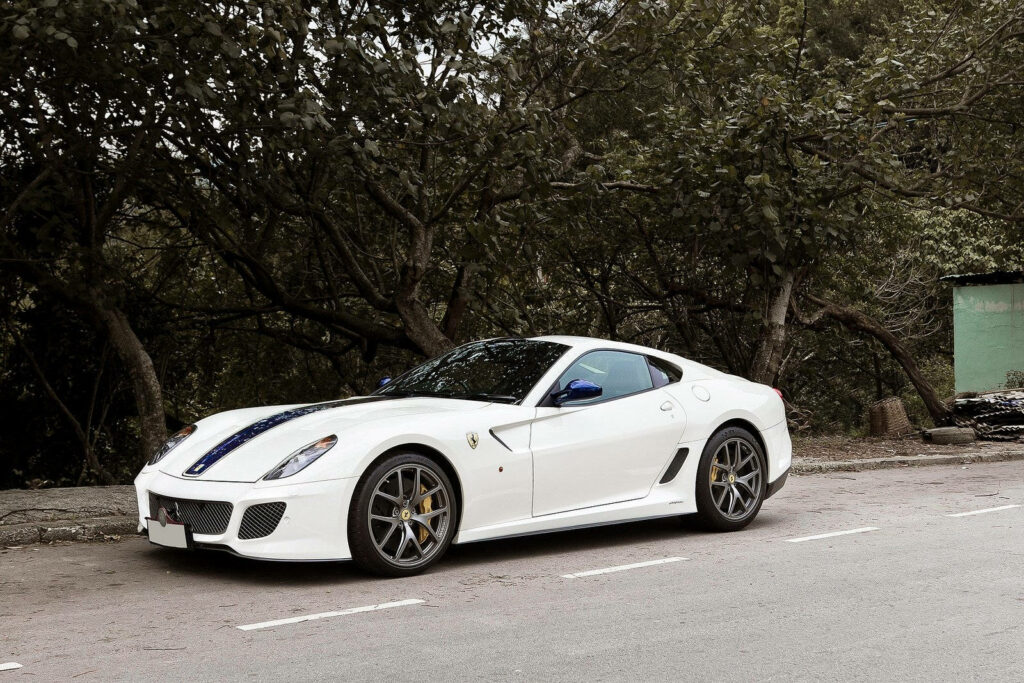 Midnight Elegance: A White Ferrari Graced by Enigmatic Shadows Wallpaper