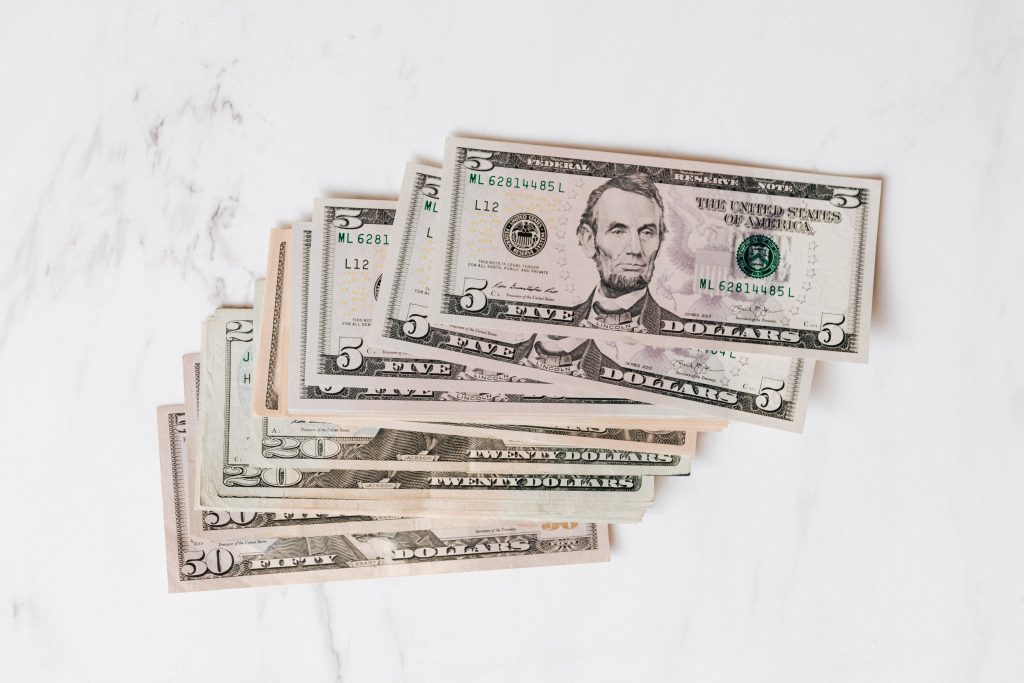 Luxury 4K wallpaper with stacked US dollar bills on white marble for stylish money background