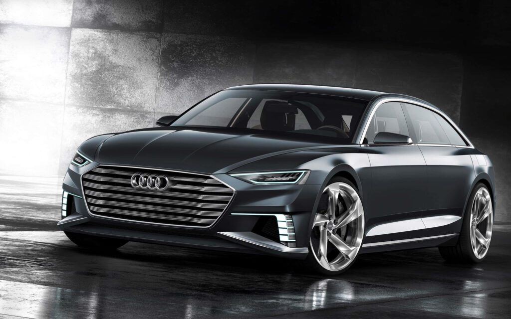 Sleek luxury black Audi in modern setting showcasing dynamic design and powerful presence wallpaper