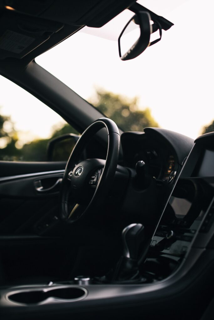 Luxurious Car Interior Wallpaper: Sleek Steering Wheel & Dashboard Design