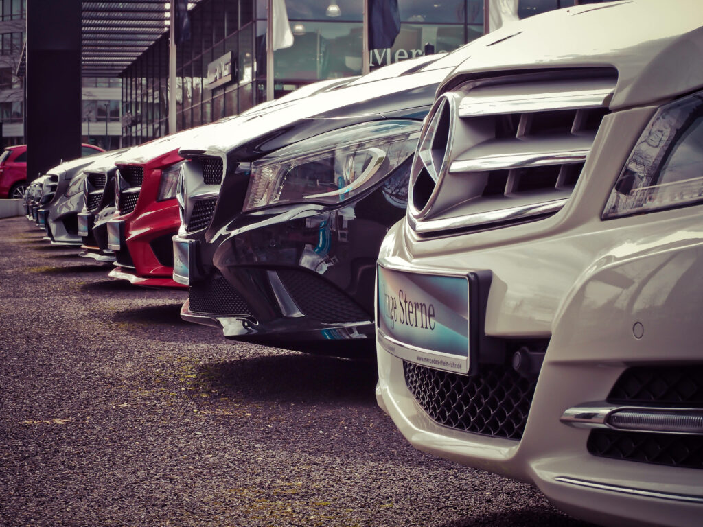 Lineup of luxury cars parked side by side creating a modern stylish 4K wallpaper background