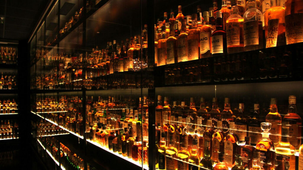 Ultimate Bar Bliss: Illuminated Drawer Storage Showcasing Exquisite Beverage Collection Wallpaper