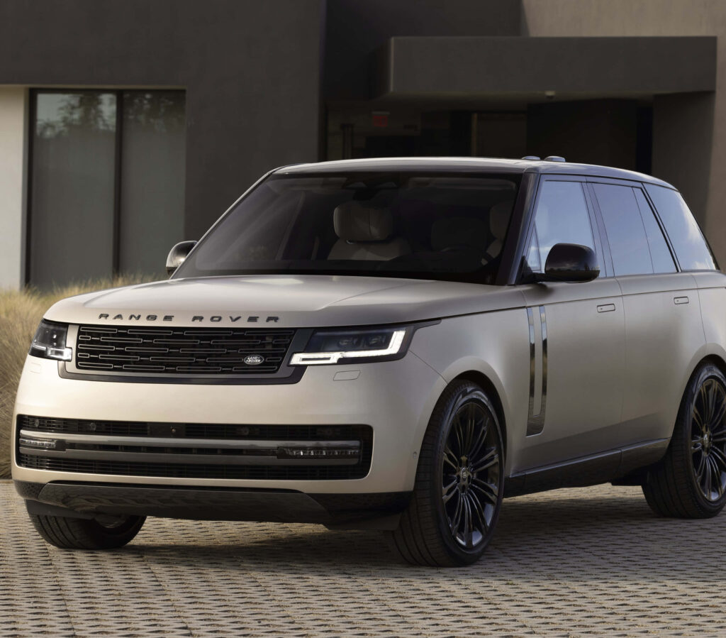Range Rover SUV parked by modern building luxury vehicle showcasing elegant design wallpaper