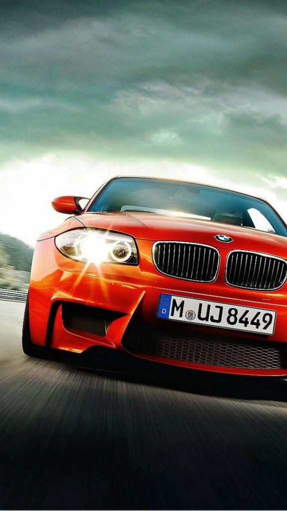 Luxurious red BMW speeding on road with dynamic motion and dramatic sky iPhone wallpaper