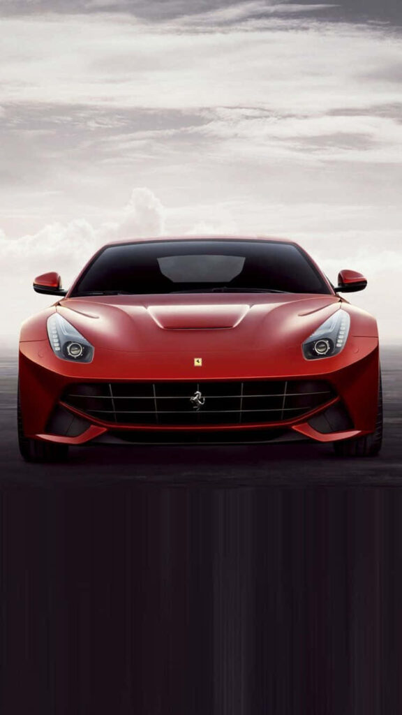 Sleek shiny red luxury car dashboard with modern iPhone and dramatic sky wallpaper background