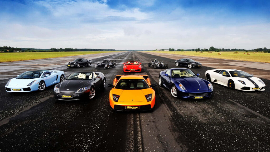 Luxury sports cars lineup on runway sleek designs vibrant colors clear blue sky wallpaper background