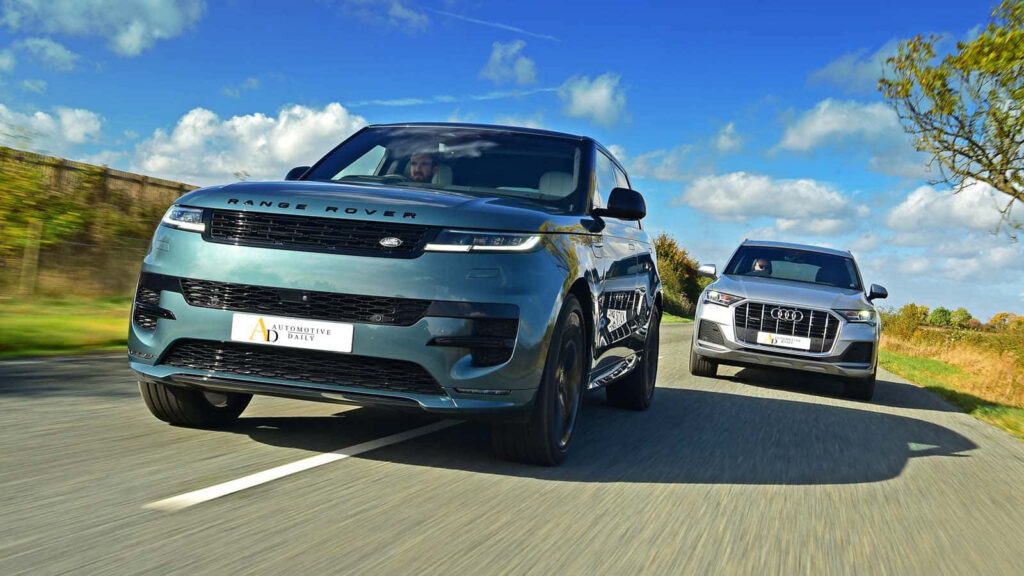 Luxury Wallpaper: Sleek Range Rover with Elegant Audi Under Blue Sky
