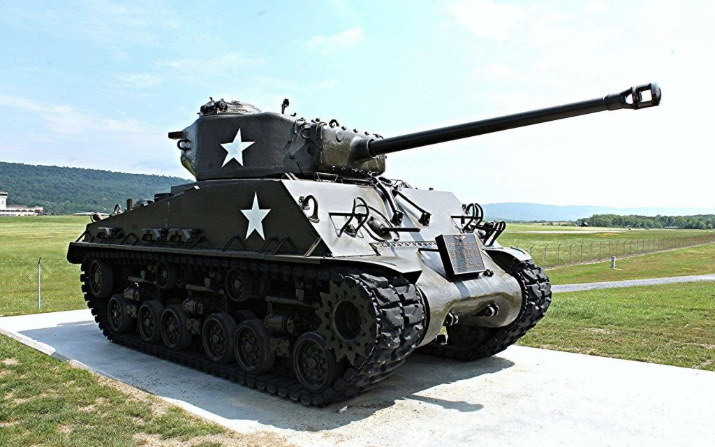 M4A3E8 Easy Eight Sherman tank on airfield with 76mm gun and WWII star markings wallpaper