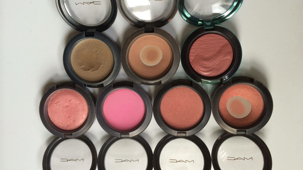 MAC cosmetics blushes and powders in diverse pink peach bronze taupe shades on white background Wallpaper