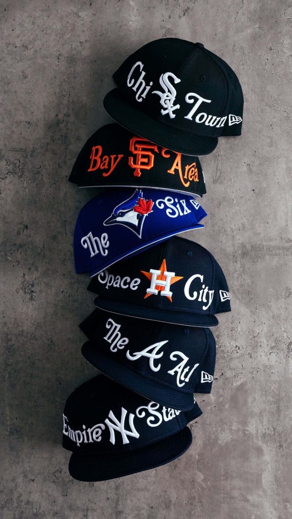 Vertical stack of MLB New Era 59Fifty fitted caps from White Sox to Yankees on concrete background Wallpaper