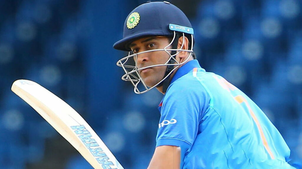 Captain Cool on the Blue Battlefield: MS Dhoni's Resolute Stance amidst Bokeh Bliss Wallpaper
