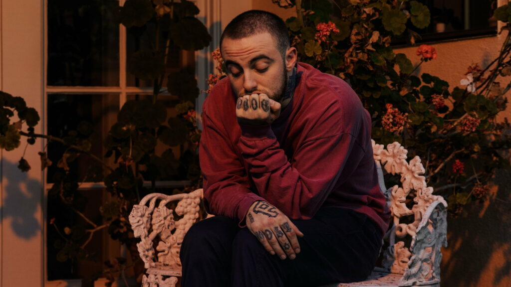 Melancholic Mac Miller: Celebrity Snapshot in Vibrant Red Tee - 4K Wallpaper