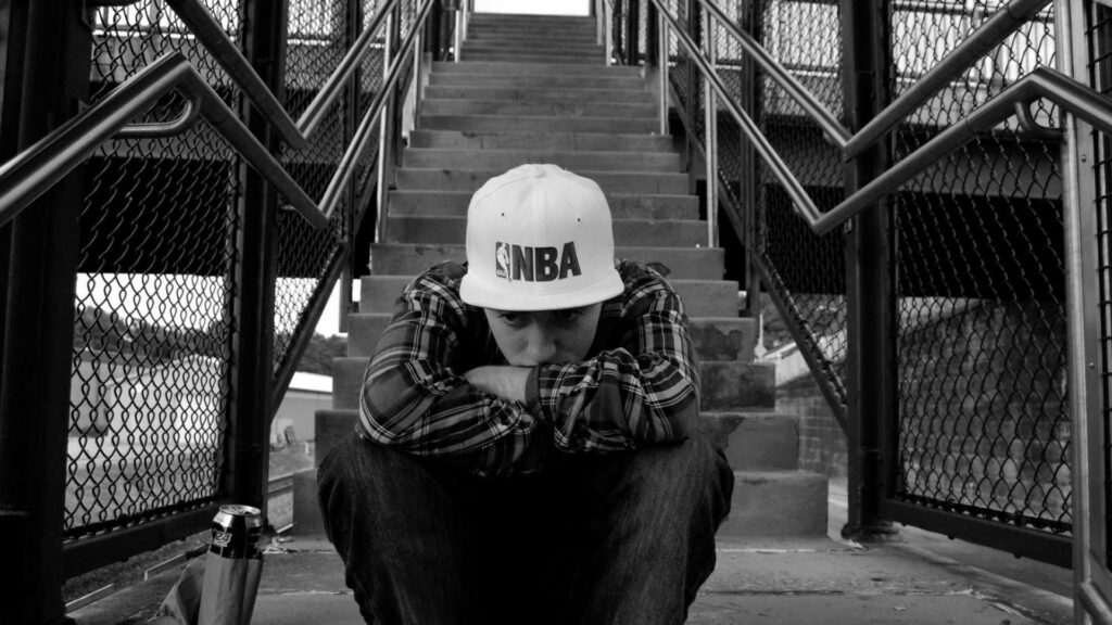 Melancholic Majesty: Mac Miller Contemplating Life on Monumental Steps Wallpaper