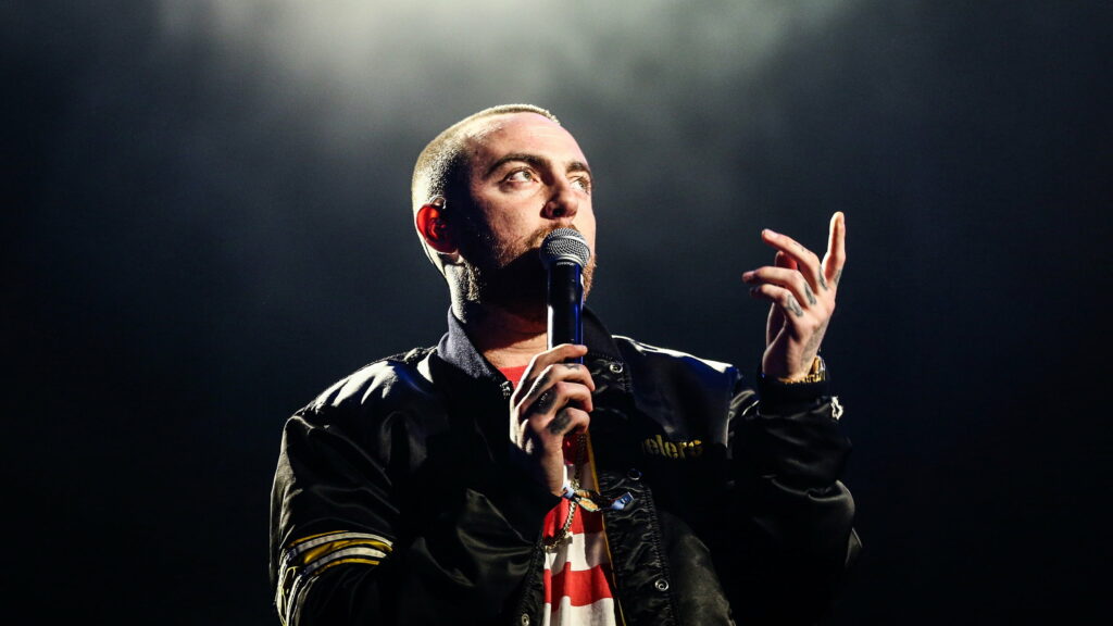 Music Sensation Mac Miller Poses with Confidence and Style - A Captivating Celeb Portrait in QHD Wallpaper