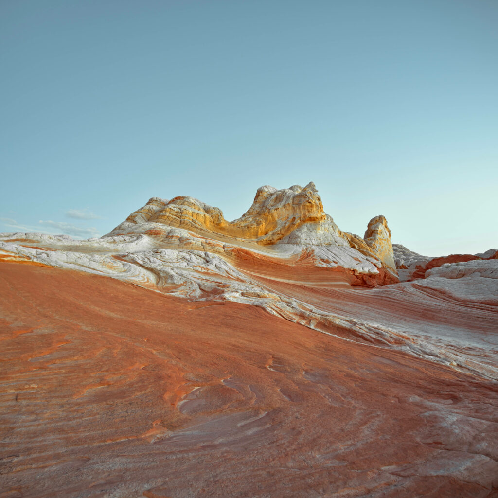 Surreal swirling sandstone formations in red orange and white at White Pocket Arizona desert landscape Wallpaper