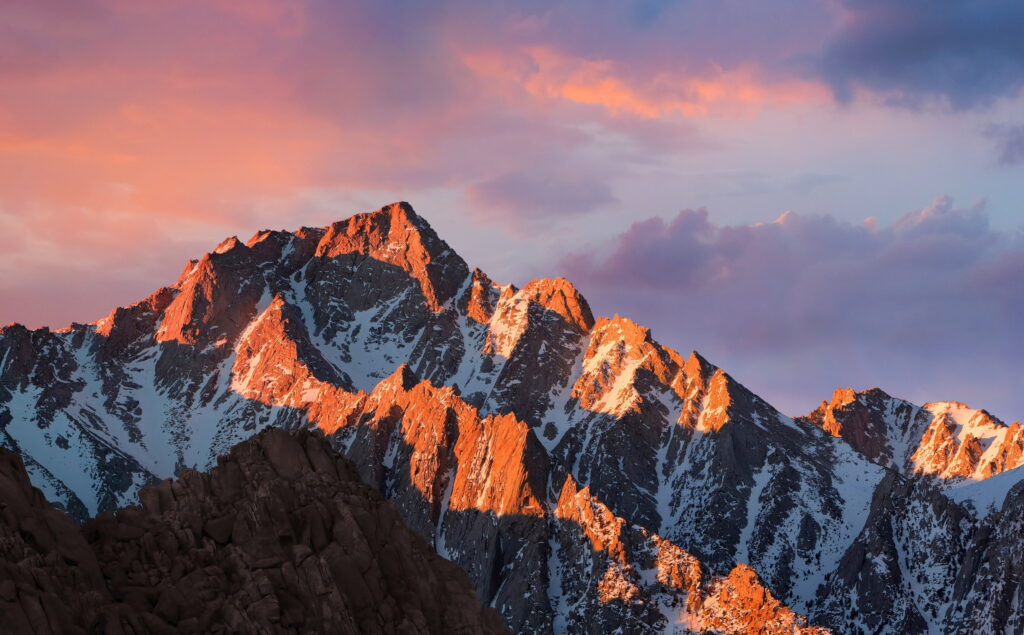 macOS Sierra wallpaper with majestic snow-capped Sierra Nevada mountains at sunrise twilight