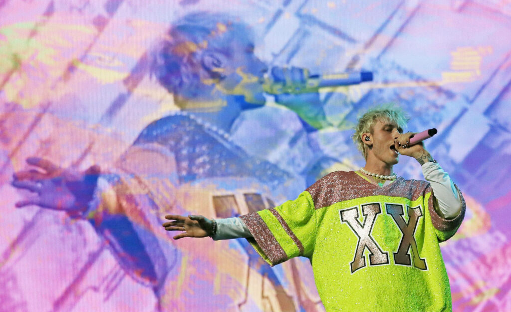 Machine Gun Kelly: Passionate Stage Performance Wallpaper Background