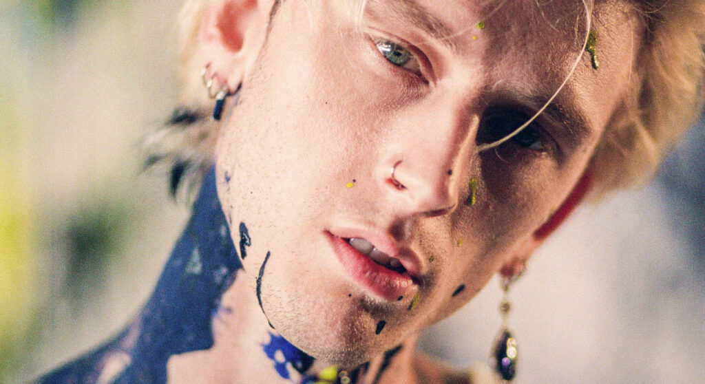 Edgy Machine Gun Kelly Portrait Wallpaper with Artistic Paint Splashes