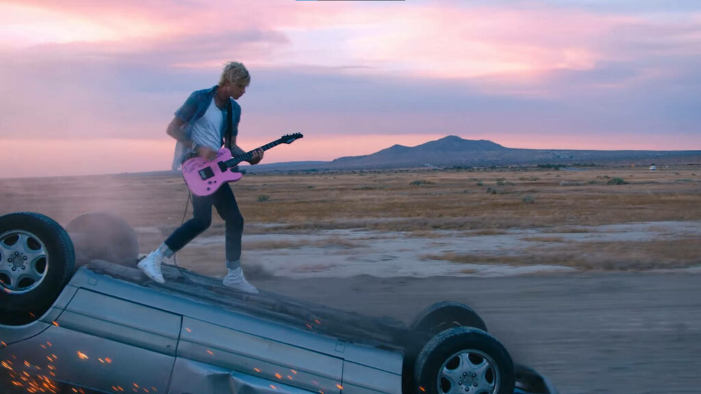 Dynamic Machine Gun Kelly Wallpaper: Sunset Desert Scene with Guitar