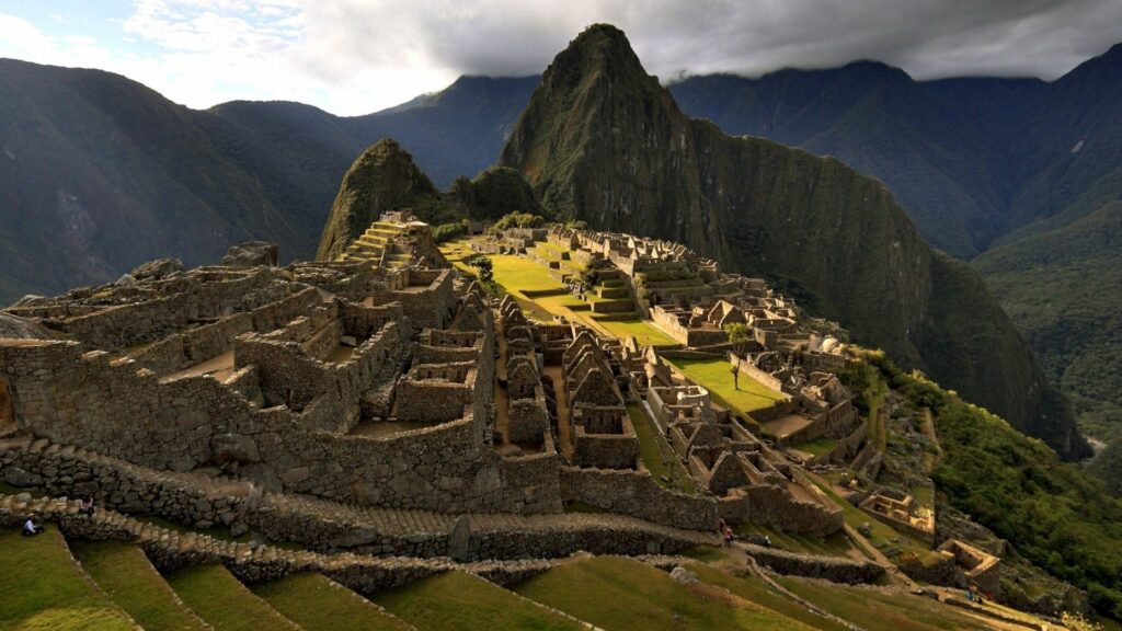 Ancient Machu Picchu ruins on lush mountain with terraced Incan stone architecture background Wallpaper