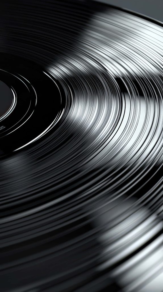 Close-up macro of black vinyl record grooves with sharp light reflections for audiophile wallpaper