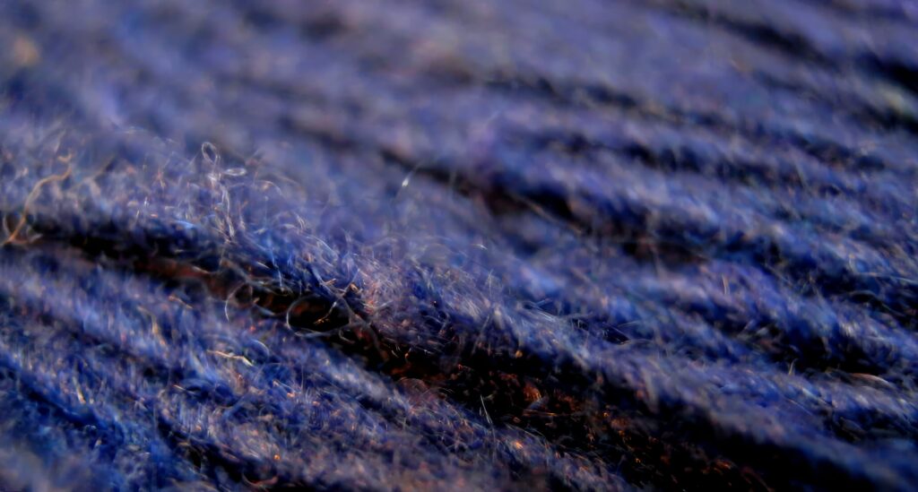 Close-Up Macro Wallpaper: Intricate Blue Yarn Threads & Soft Background