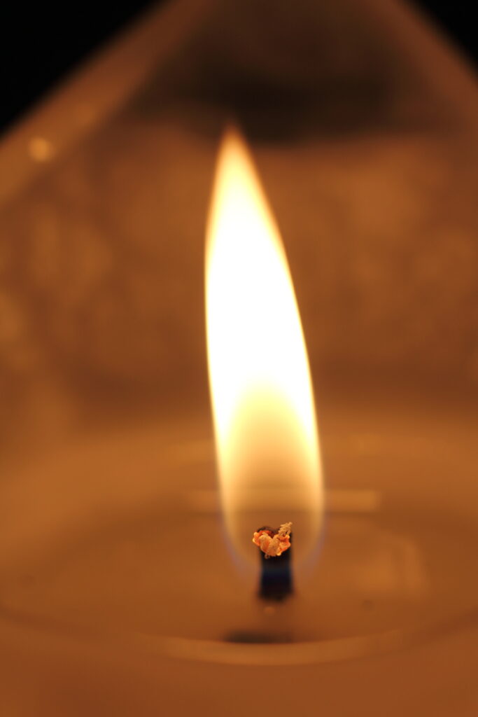 Macro View of Candle Flame: Warm Golden Light Wallpaper Background