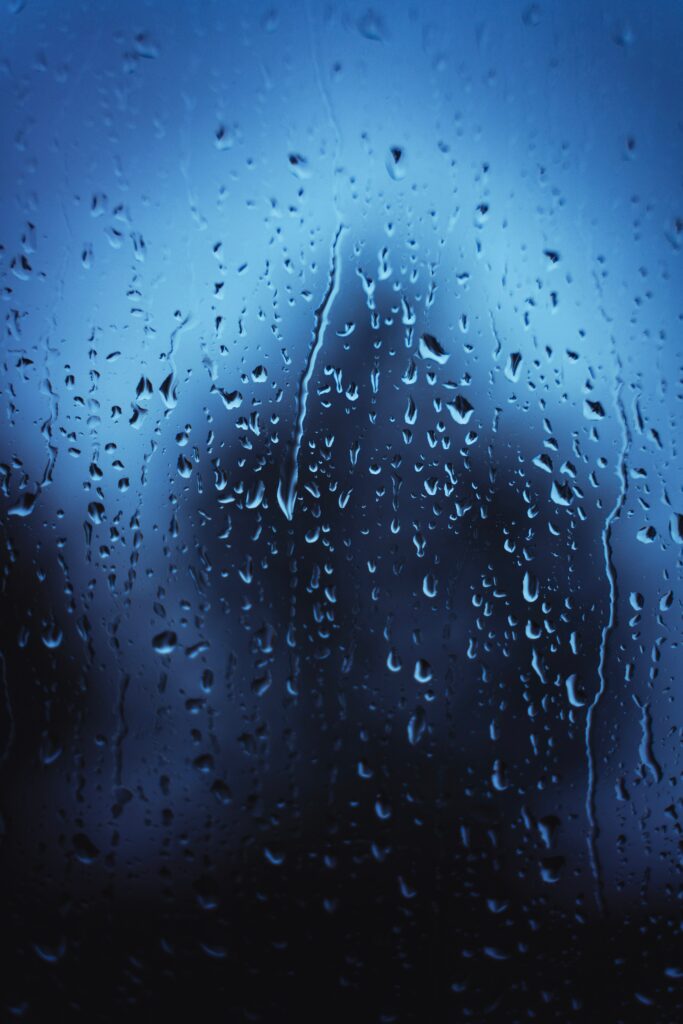 Macro Close-Up of Water Droplets on Glass - Soft Blue Wallpaper