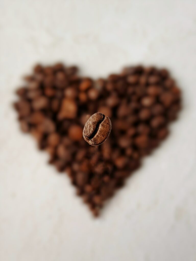 Macro Coffee Bean Close-Up with Heart-Shaped Blurred Background Wallpaper