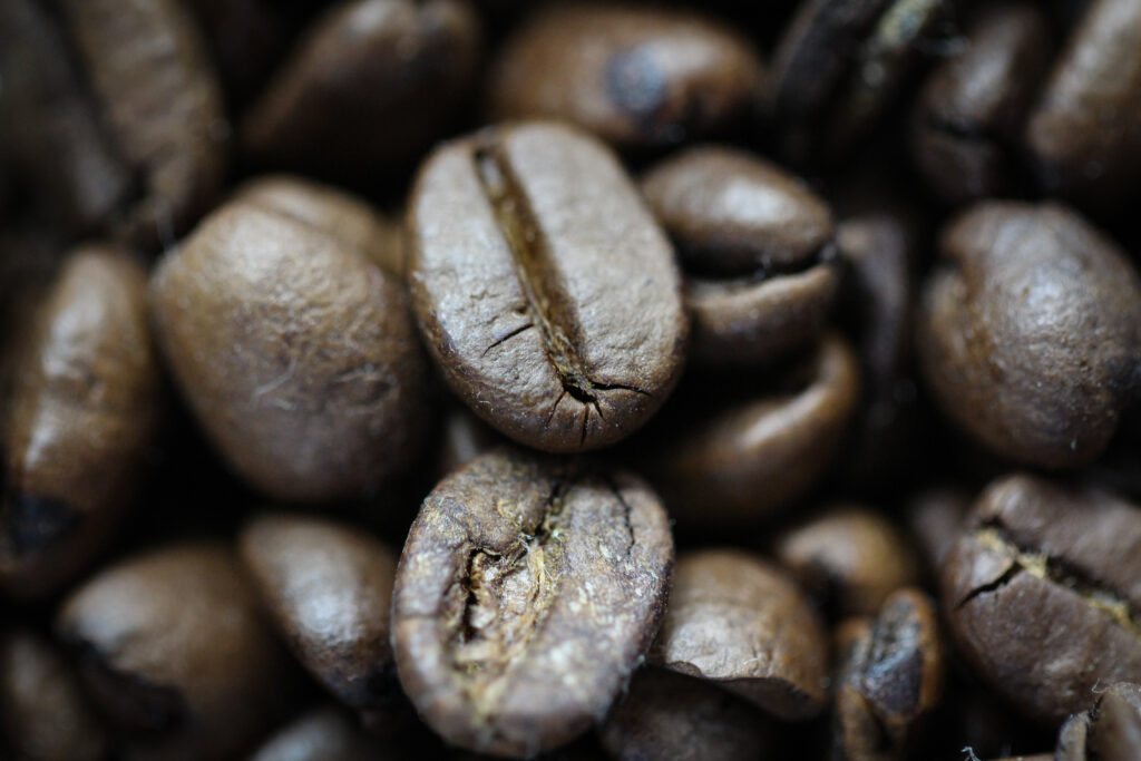 Macro Close-Up of Rich Roasted Coffee Beans - Wallpaper Background