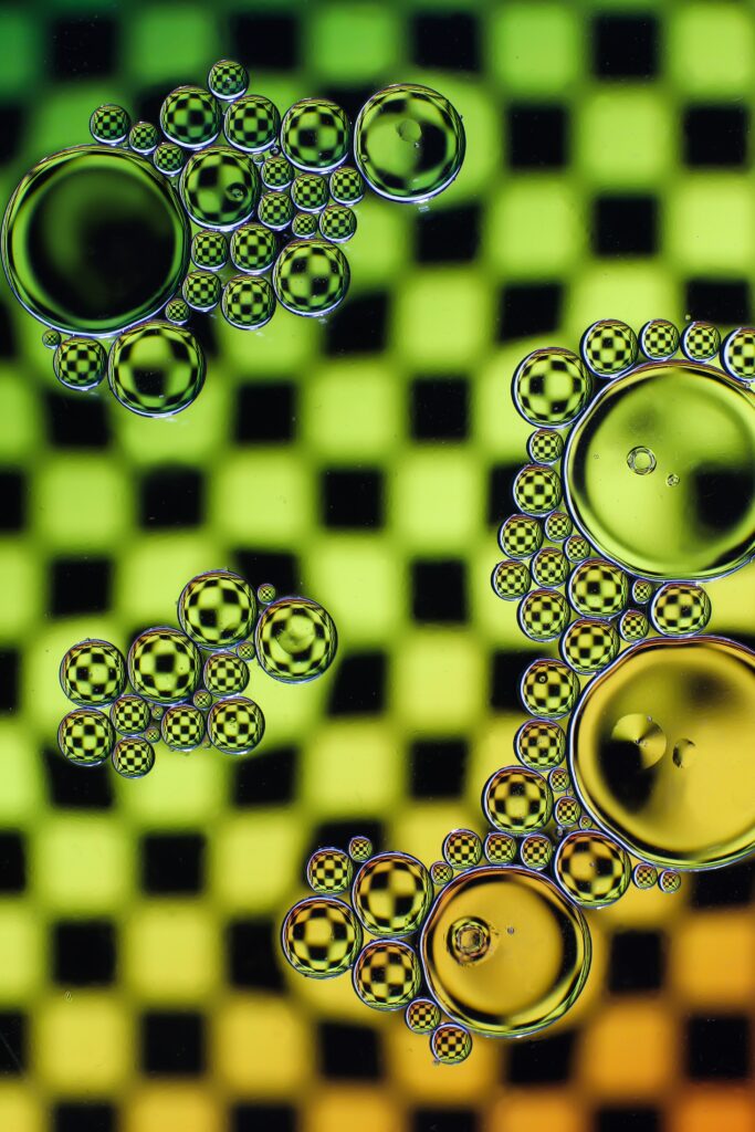 Intricate Oil Bubble Macro Wallpaper on Green & Yellow Checkered Background