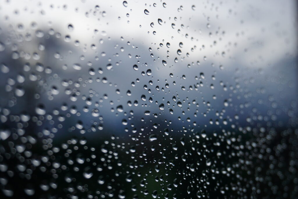 Macro Wallpaper: Water Droplets on Glass with Blurred Nature Background