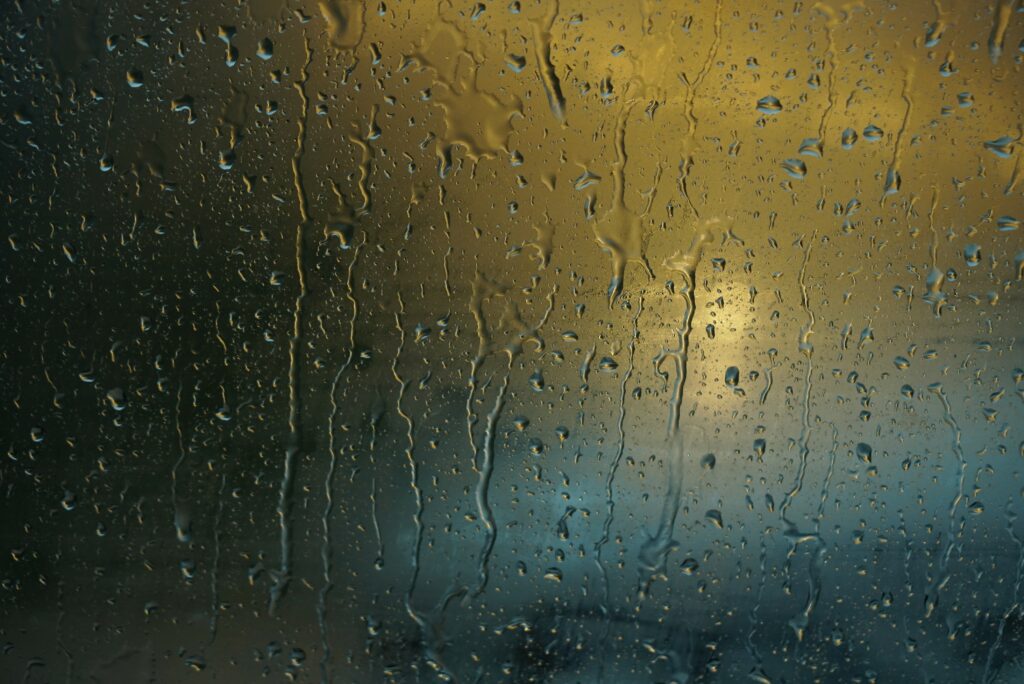 Macro Water Droplets on Glass: Warm Light Wallpaper Background