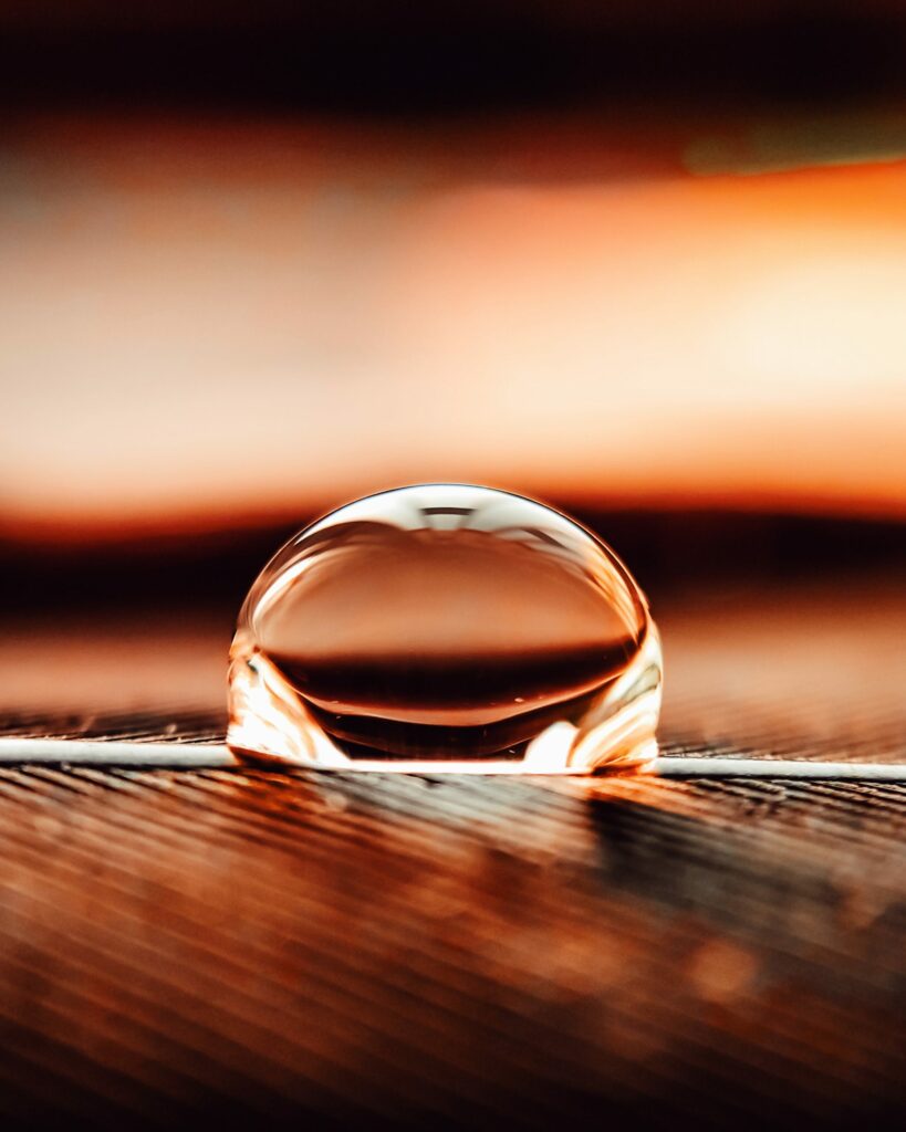 Serene Macro Shot of Water Droplet on Textured Surface | Wallpaper