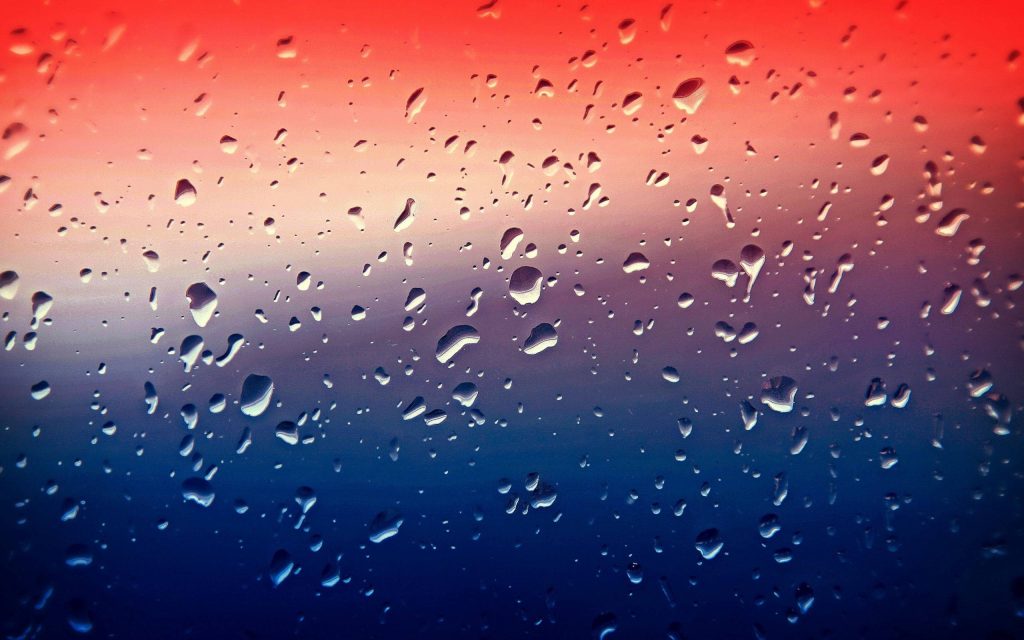 Macro water droplets on glass with vibrant red to blue gradient 4K UHD wallpaper background