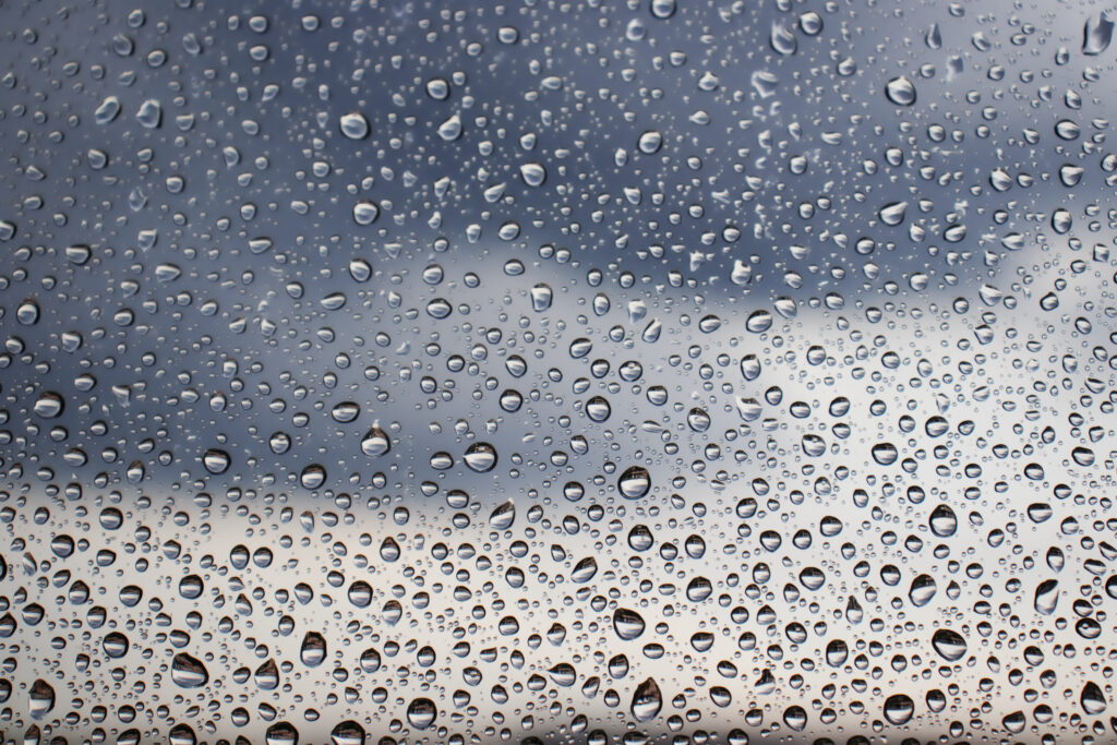 Macro Water Droplets on Glass Wallpaper: Rainy Sky Atmosphere