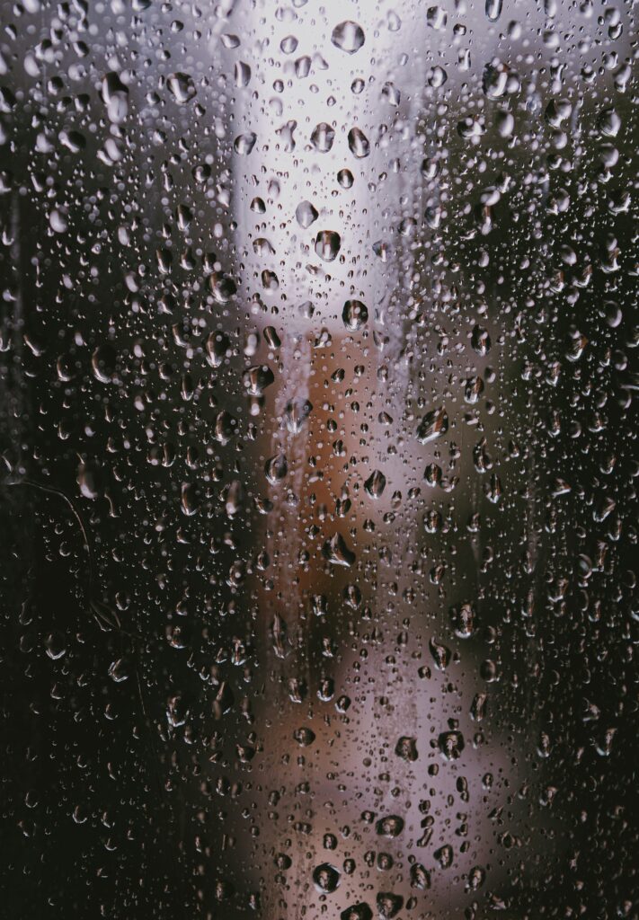 Macro Water Droplets on Glass: Reflective Texture Wallpaper Background