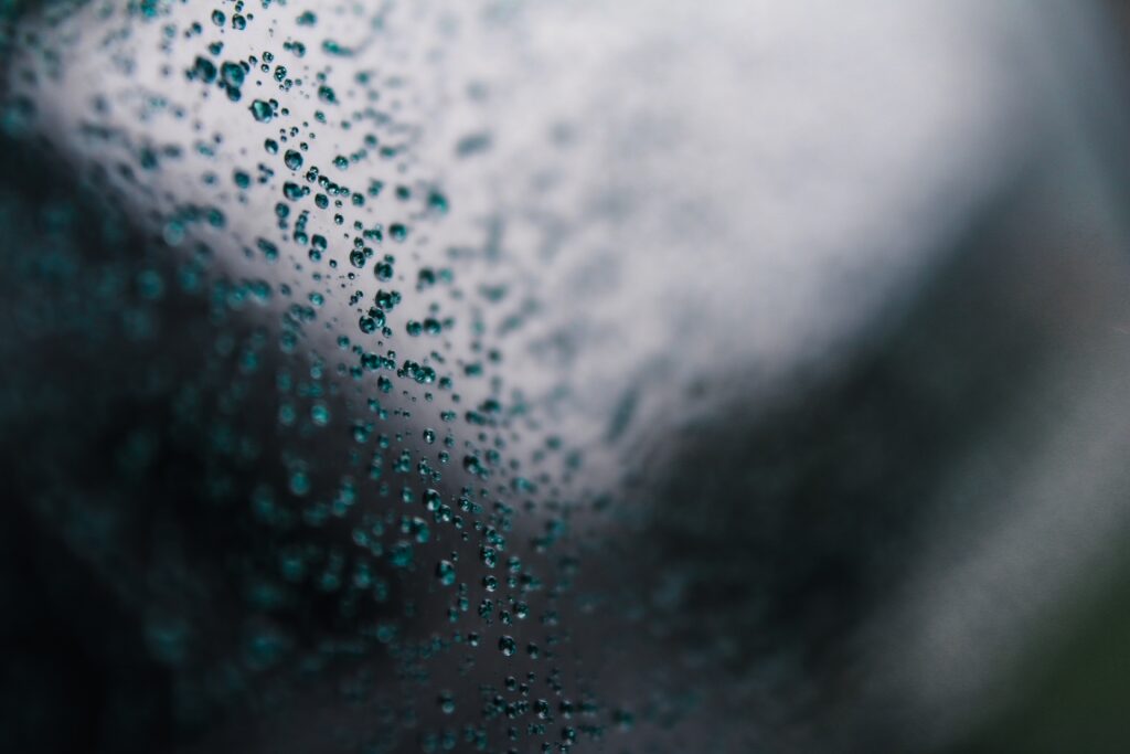 Macro Water Droplets on Glass: Serene Abstract Wallpaper Background