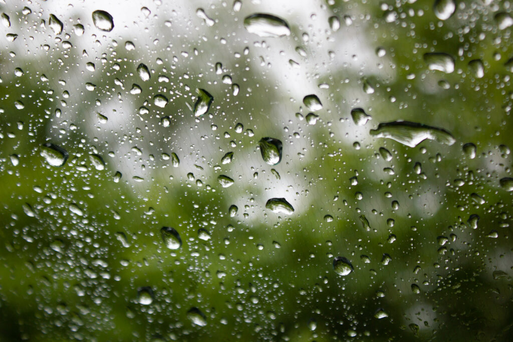 Macro Water Droplets on Glass: Fresh Rainy Ambiance Wallpaper