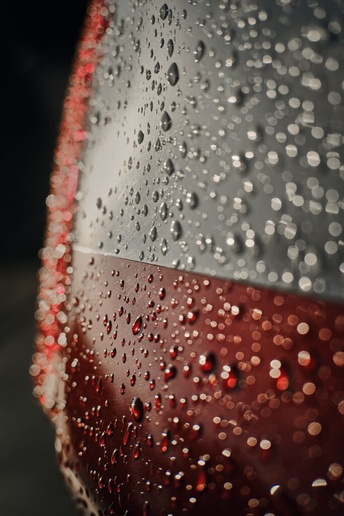 Macro Water Droplets on Glossy Red and White Wallpaper Background
