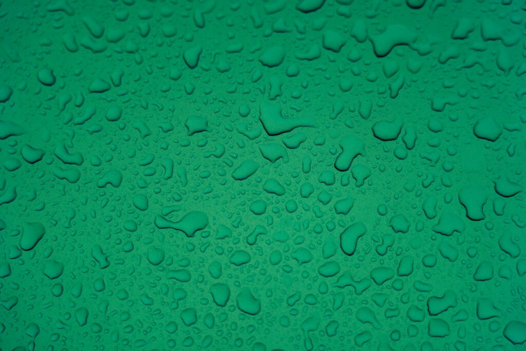 Macro Water Droplets on Vibrant Green Wallpaper Background