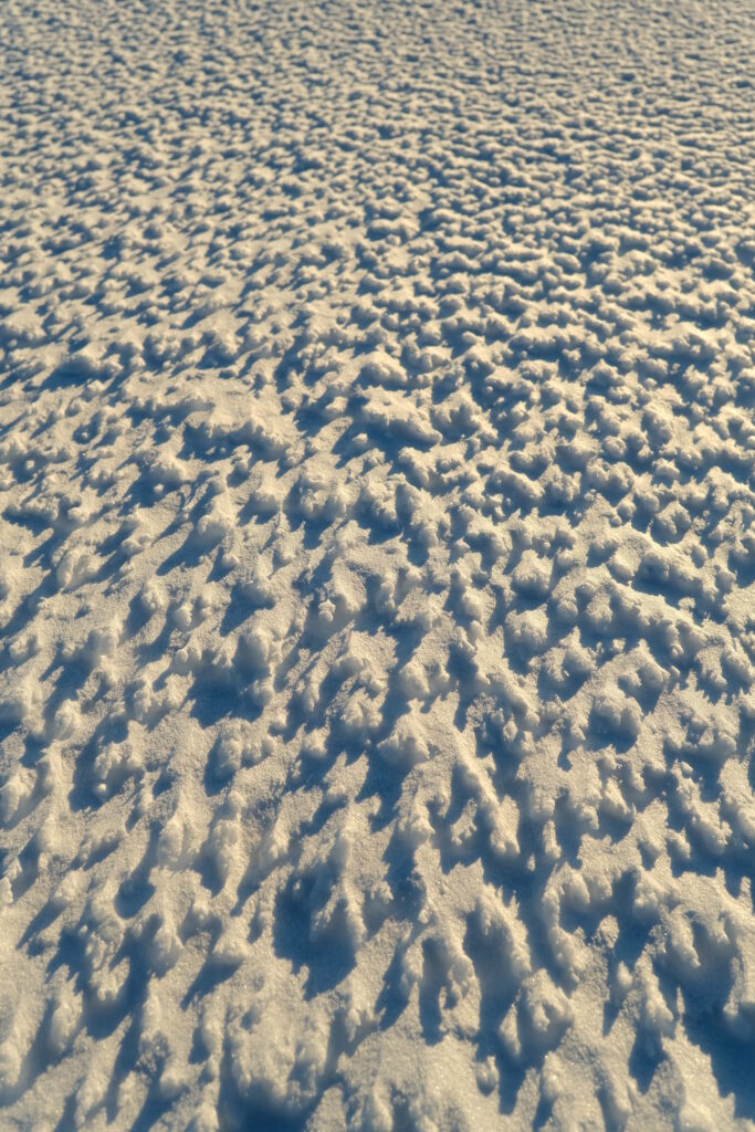 Stunning Snow-Covered Surface: Intricate Winter Patterns in Macro Wallpaper